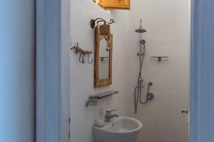a bathroom with a sink and a mirror on the wall at Casa Falco Della Regina in Filicudi