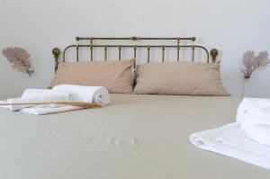 a bed with two towels and pillows on it at Casa Falco Della Regina in Filicudi
