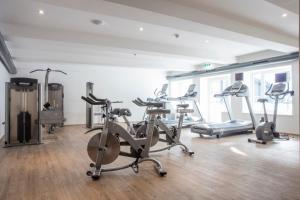 a gym with several exercise bikes in a room at Rauriserhof in Rauris