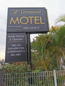 a sign that is on top of a pole at Limassol Motel in Gold Coast