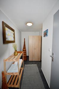 a room with a hallway with a table and a door at Apartmán v prírode s vlastnou saunou in Martin