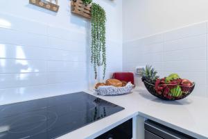 a kitchen with a bowl of fruit and a bowl of bread at New apartment in the heart of Jerusalem ! in Jerusalem +29 photos