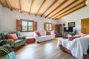 una sala de estar con sofás y techo de madera. en Can Baixo en Puerto de Sóller