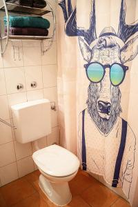 a bathroom with a shower curtain with a deer wearing sunglasses at Predigtstuhlblick Apartment - Terrasse - Pool - Panorama in Bad Reichenhall