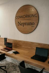 a laptop computer sitting on top of a wooden desk at MUR Neptuno Gran Canaria - Adults Only in Playa del Ingles