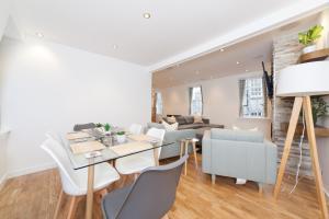 a dining room and living room with a table and chairs at Queensferry Street Lane - Fantastic 2 BR City Centre Mews House with free secure parking! in Edinburgh