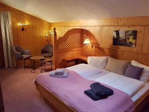 a bedroom with a large bed with a purple blanket at Gasthof und Panoramastellplatz Friedburg in Neukirchen am Großvenediger