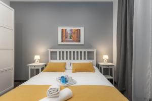 a bedroom with a bed with towels on it at Apartment LUX HOME in Rijeka