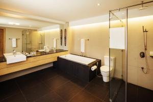 
a bathroom with a shower, toilet, sink and tub at Villa Caemilla Beach Boutique Hotel in Boracay
