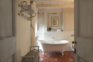 a white bath tub sitting next to a white sink at Torre a Cona Wine Estate in Florence