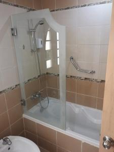 a bathroom with a shower and a toilet and a sink at Royal Lagoons Resort & Aqua Park Families and Couples Only in Hurghada