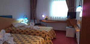 Postel nebo postele na pokoji v ubytování Iris Hotel
