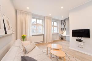 Televízia a/alebo spoločenská miestnosť v ubytovaní Apartamenty Grobla III Q4Apartments