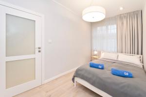 Posteľ alebo postele v izbe v ubytovaní Apartamenty Grobla III Q4Apartments