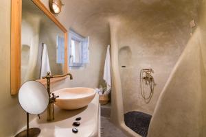 a bathroom with a sink and a shower at Pezoules of Oia in Oia