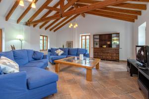 a living room with blue couches and a coffee table at Villa Muscarolas By home villas 360 in Pollença