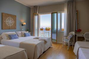 Postel nebo postele na pokoji v ubytování Hotel Punta Nord Est