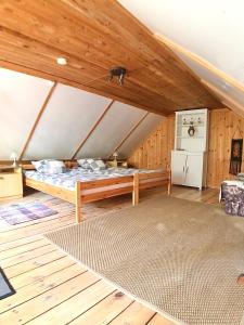 a large room with a bed in a attic at Pod lipą in Ruciane-Nida