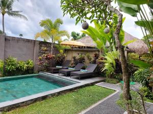 a villa with a swimming pool and a resort at Bali Sila Bisma in Ubud