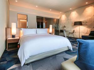 a large white bed in a hotel room at Sofitel Mexico City Reforma in Mexico City