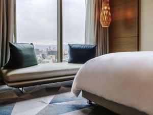 a hotel room with a bed and a window at Sofitel Mexico City Reforma in Mexico City