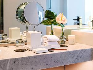 a bathroom counter with a mirror and a sink at Sofitel Mexico City Reforma in Mexico City