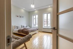 a bedroom with a bed and a window at InshiApartments on Grigorenko's square in Lviv