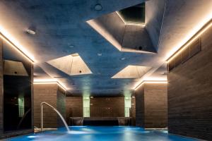a large swimming pool in a room with a ceiling at Grandhotel Pupp in Karlovy Vary