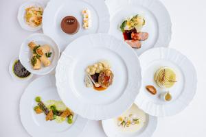 
a white table topped with plates of food at Grandhotel Pupp in Karlovy Vary
