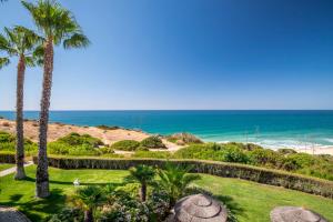 a view of the beach from a resort with palm trees at Clube Porto Mos - Sunplace Hotels & Beach Resort in Lagos