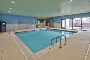 a large swimming pool in a building at Holiday Inn Express & Suites - Albuquerque East, an IHG Hotel in Albuquerque