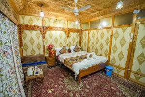 a bedroom with a bed in a room at Houseboat Altaf and transportation in Srinagar