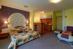a hotel room with a bed and a kitchen at Evridika Apartments in Nesebar