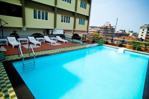 a large swimming pool on top of a building at Paramount Tower in Kozhikode