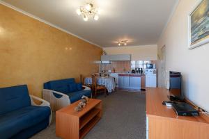 a living room with a blue couch and a table at Evridika Apartments in Nesebar