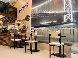a restaurant with chairs and a bridge on the wall at Great House 99 in Bangkok