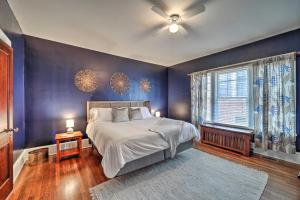 a bedroom with a bed and a blue wall at Bristol Bungalow Less Than 1 Mi to Country Music Museum in Bristol