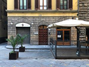 a building with two doors and an umbrella at Relais Del Duomo in Florence