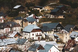 an aerial view of a village with snow covered roofs at Gite L'Aurienchon in Auris