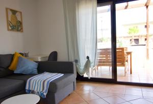 a living room with a couch and a sliding glass door at The Wind's Breath, perfect for relaxing getaway in La Oliva