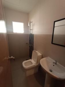 a bathroom with a toilet and a sink at Anaya Beach Resort in Bantayan Island