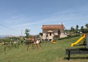 a park with a playground with a slide and a building at Locanda Arcadia in Picerno