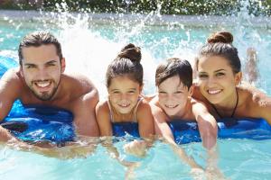 a family in the water in a swimming pool at Vincci EverEden in Anavyssos