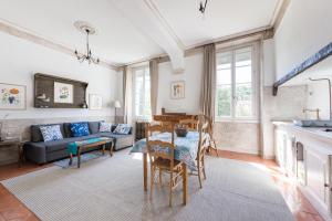 a living room with a table and a couch at Maison Sule in Malaucène
