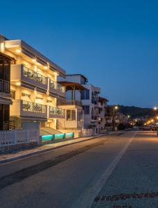 an empty street in front of a building at night at Privilege Luxury Living in Sarti