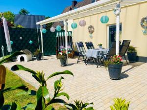 a patio with a table and chairs on a patio at Apartment Glesch in Bergheim +18 photos