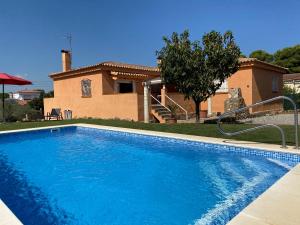 a swimming pool in front of a house at Masos de Pals in Pals