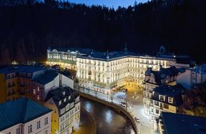 a city with a large building and a river at Grandhotel Pupp in Karlovy Vary