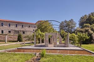 a monument in front of a building at Eurostars Monumento Monasterio de San Clodio Hotel in Leiro