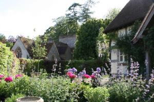 a garden with flowers in front of a house at Remarkable 1-Bed Cottage near Henley-on-Thames in Henley on Thames